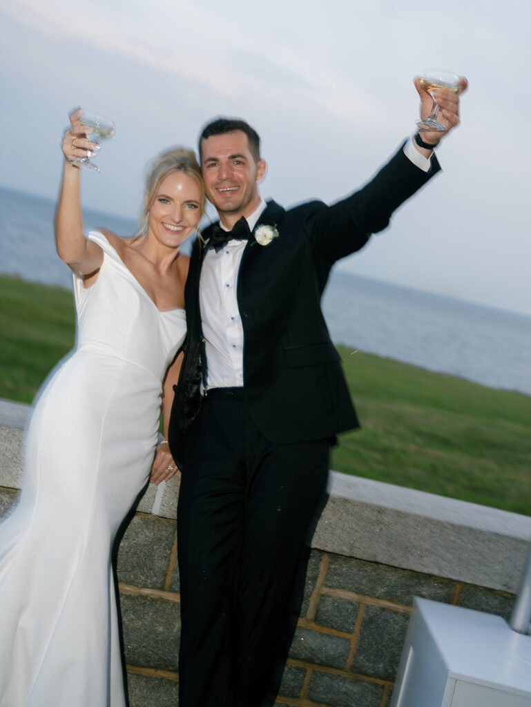 Bride and groom saying Cheers and looking at the camera