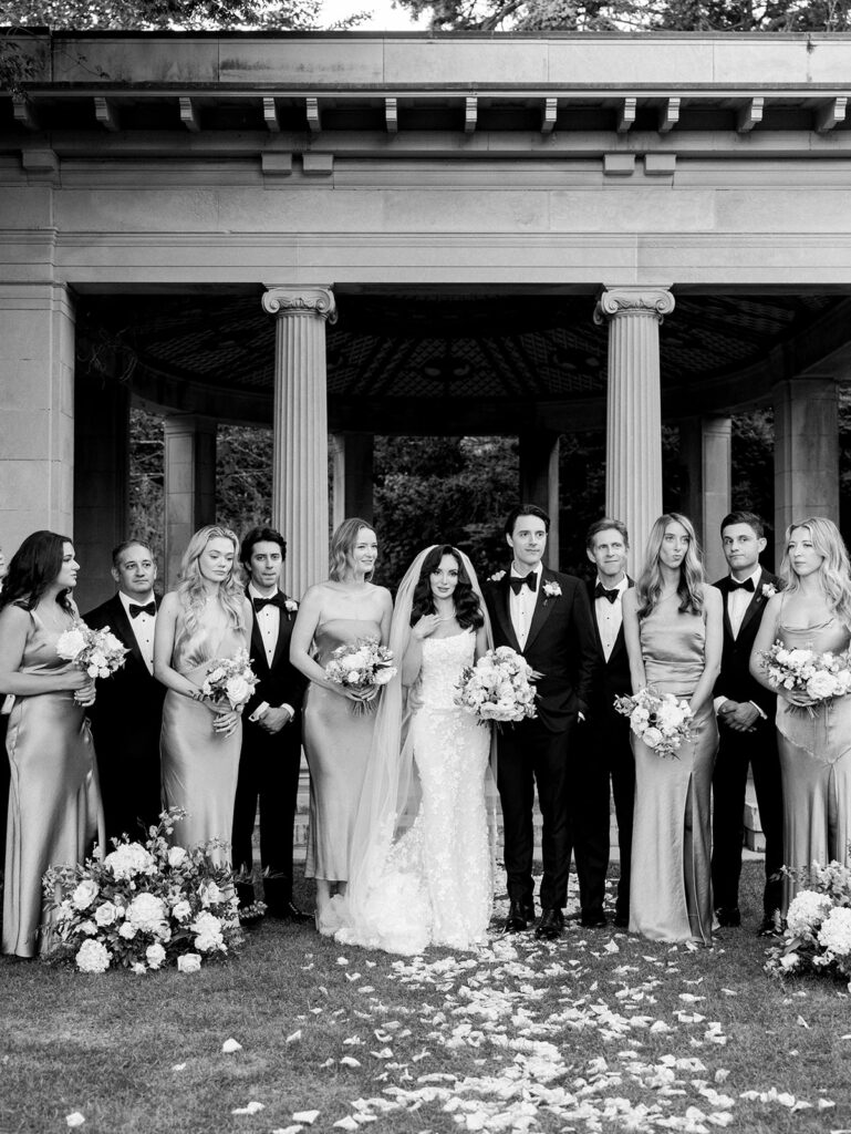 A candid photo of the wedding party while they wait to pose for a portrait.