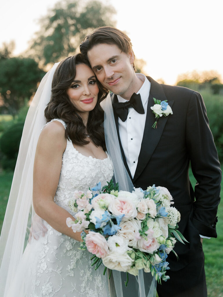 bride and groom looking at the camera for a portrait at sunset