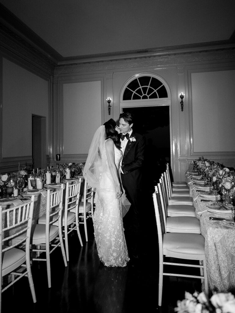 Bride and groom kissing in the reception space at their Eolia Mansion wedding