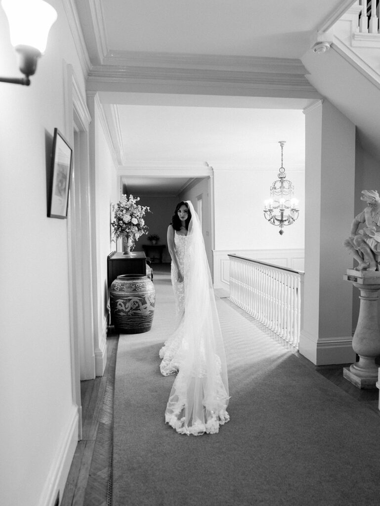 Bride getting ready at Eolia Mansion standing in the hallway about to go down the stairs