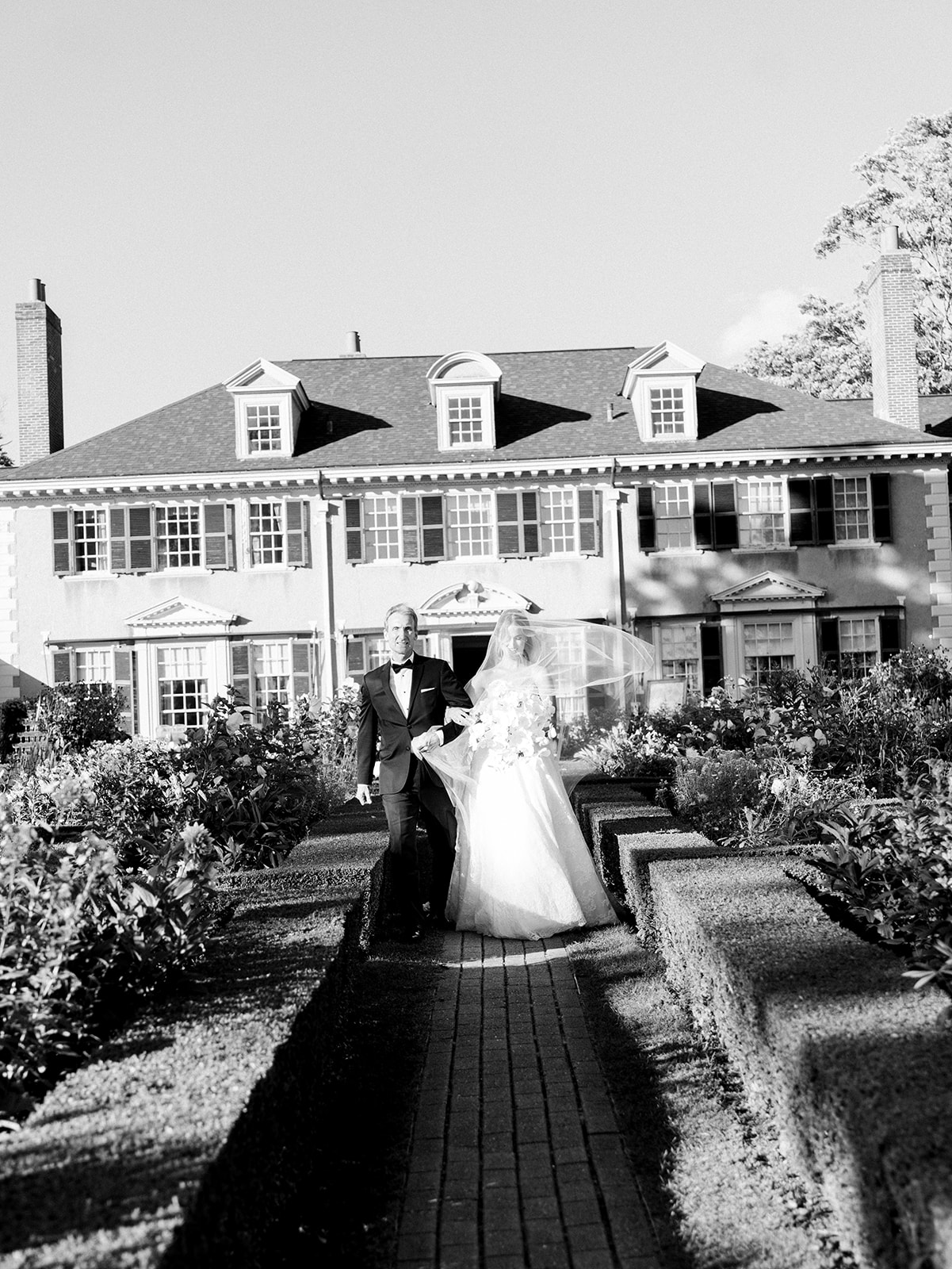 The bride walking down the aisle with her father.