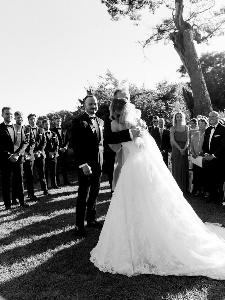 The bride's father giving her away at the altar.