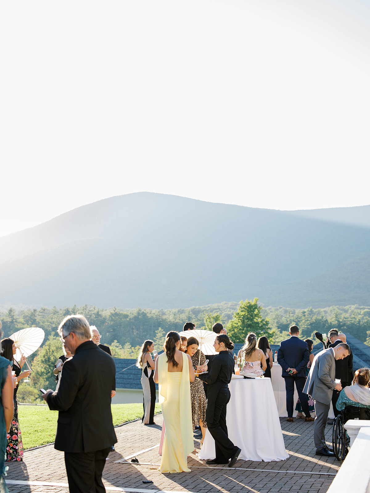 Guests enjoying cocktail hour in the golden hour sun.