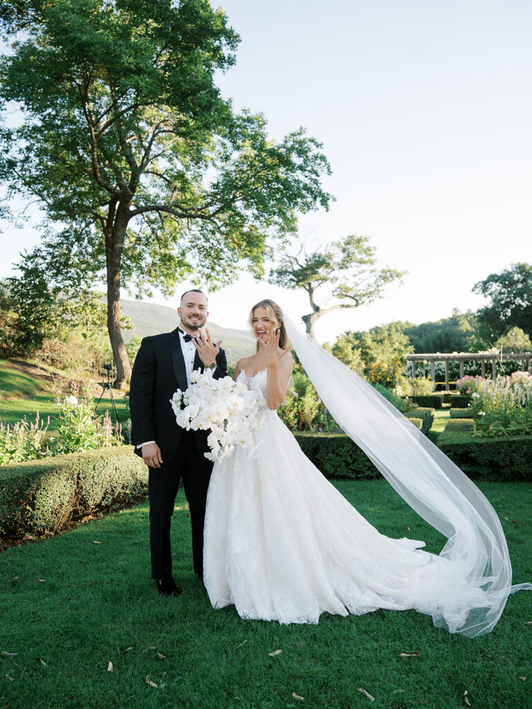 The bride and groom showing the camera their new weddings rings at their Hildene Wedding