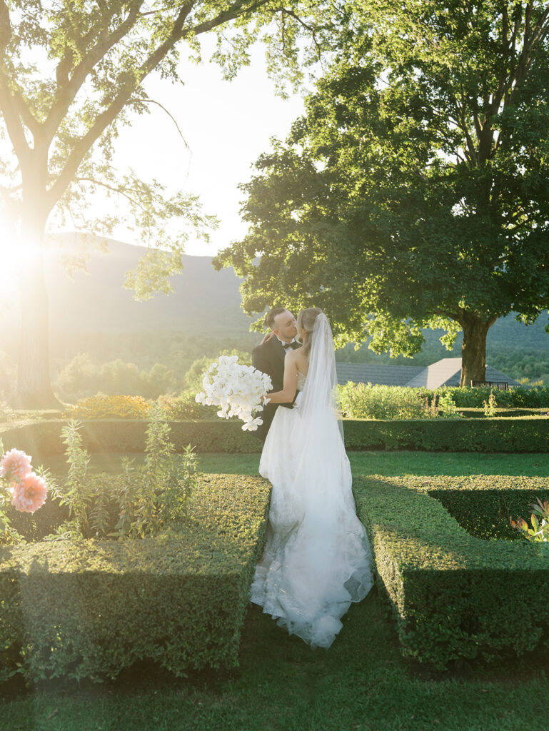 The bride and groom posing for a portrait in the golden hour sun.