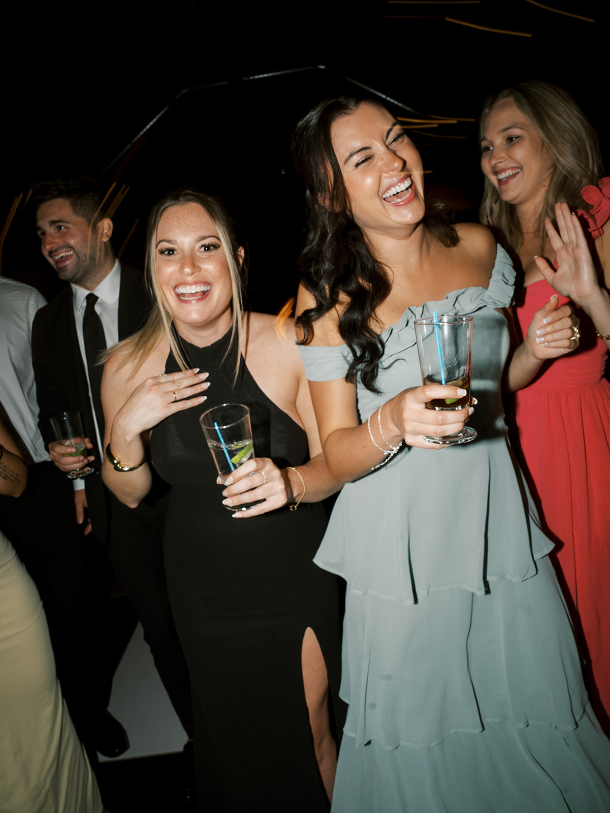 Guests laughing and dancing on the dance floor.