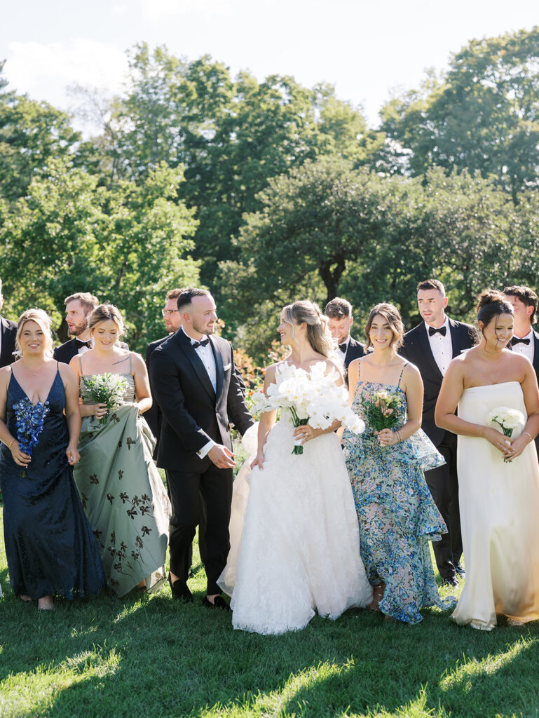 The wedding party taking a candid photo together in the gardens at their Hildene wedding.