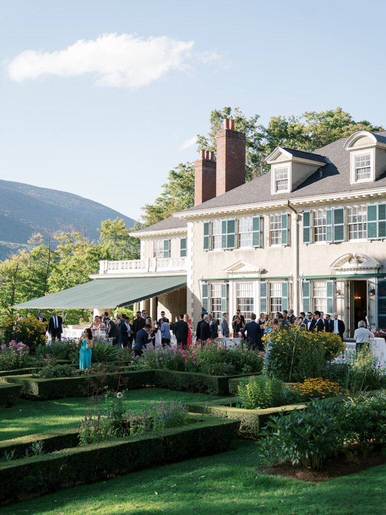 Guests arriving in a pulled back view of the Hildene.