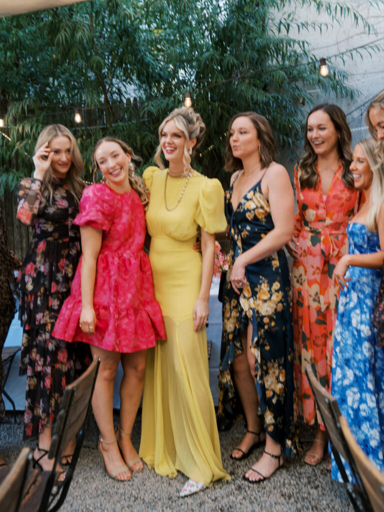 The bride with her friends laughing and posing for a portrait.