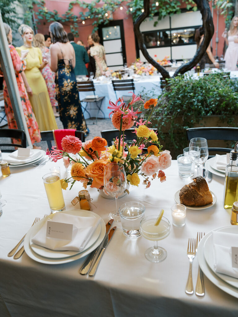 A view of the tablescapes with people in the background chatting.