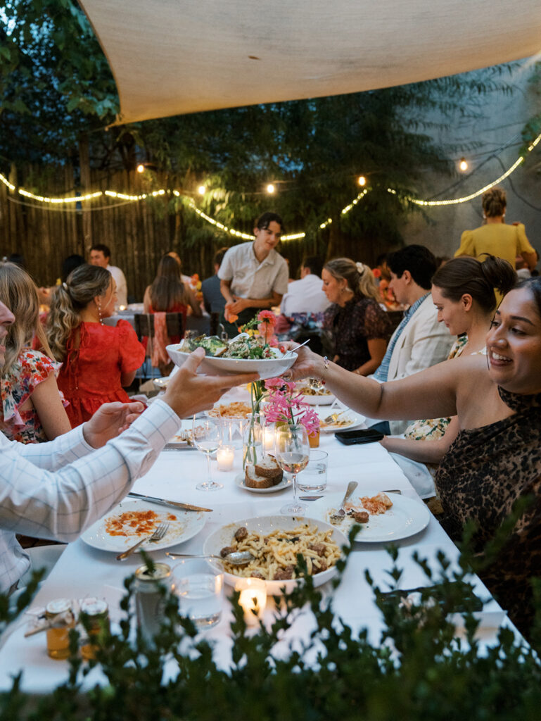 Passing family style dinner plates across the table.