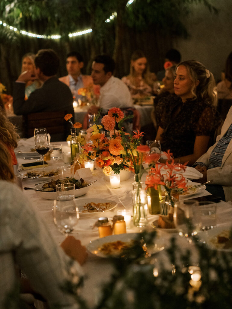 The guests enjoying speeches in a glowy picture of the tables.