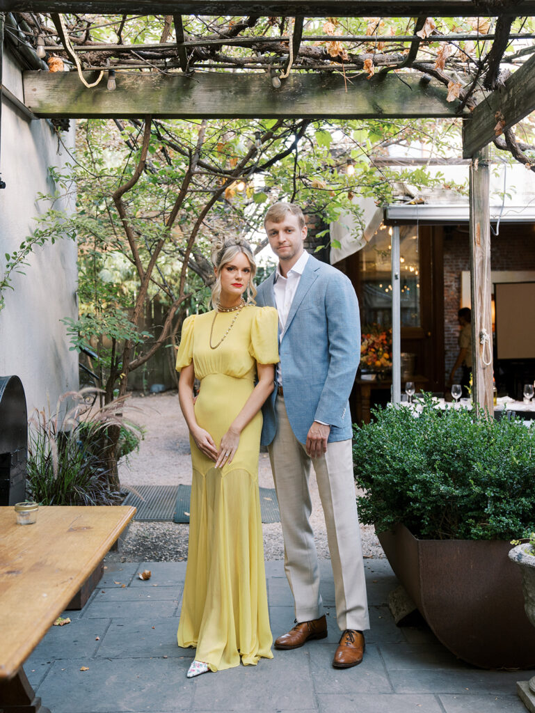 The couple posing for a portrait at their Brooklyn Rehearsal Dinner