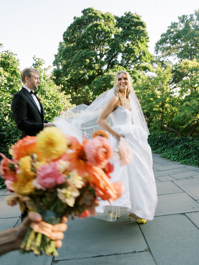 The bride and groom walking quickly at their Brooklyn Botanic Wedding.