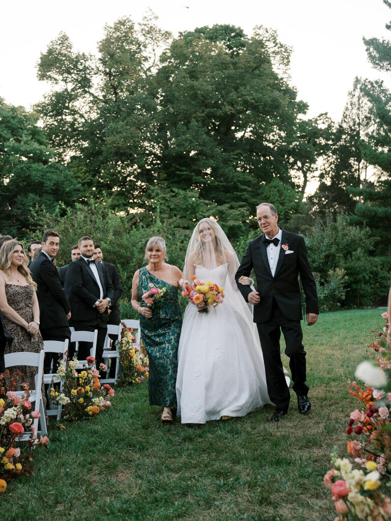 Parents walking the bride down the aisle.