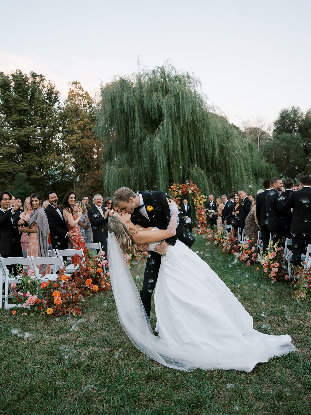 Bride and groom kissing during their recessional at their brooklyn botanic wedding