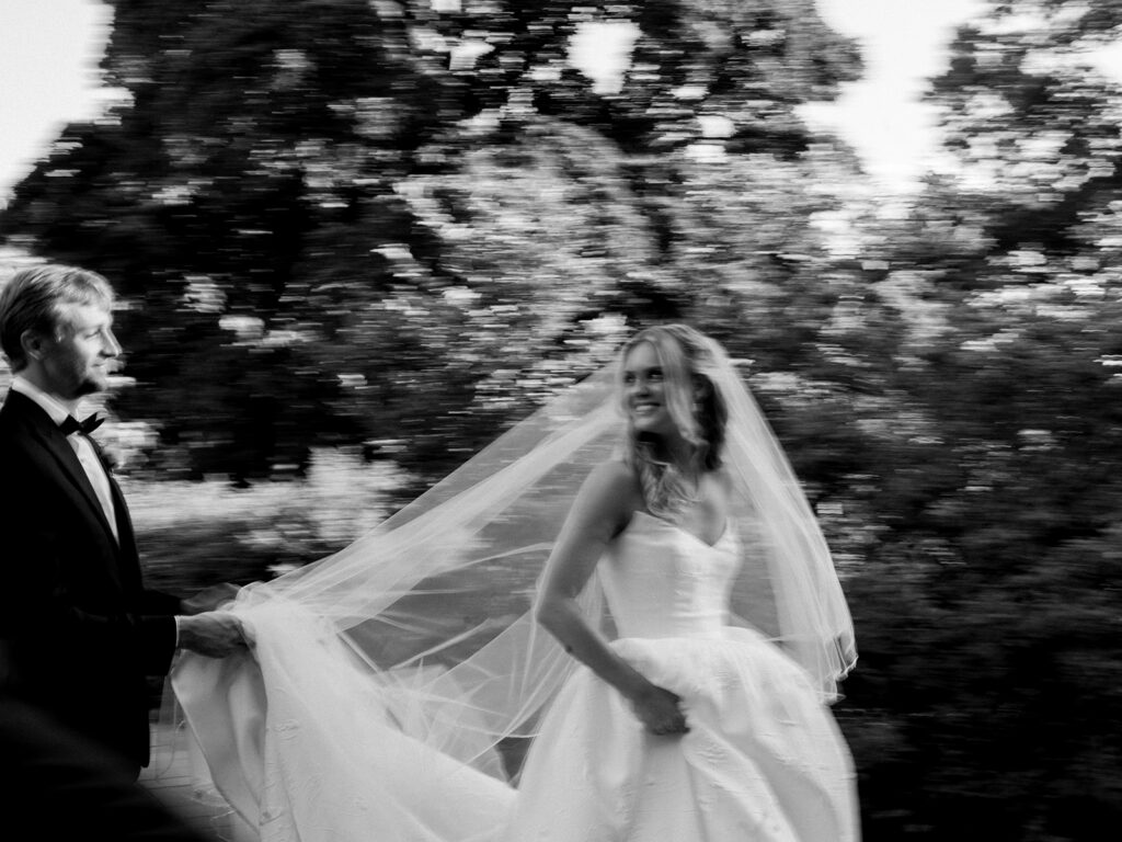 Blurry black and white of bride looking back at groom from the side at Brooklyn Botanic Wedding.