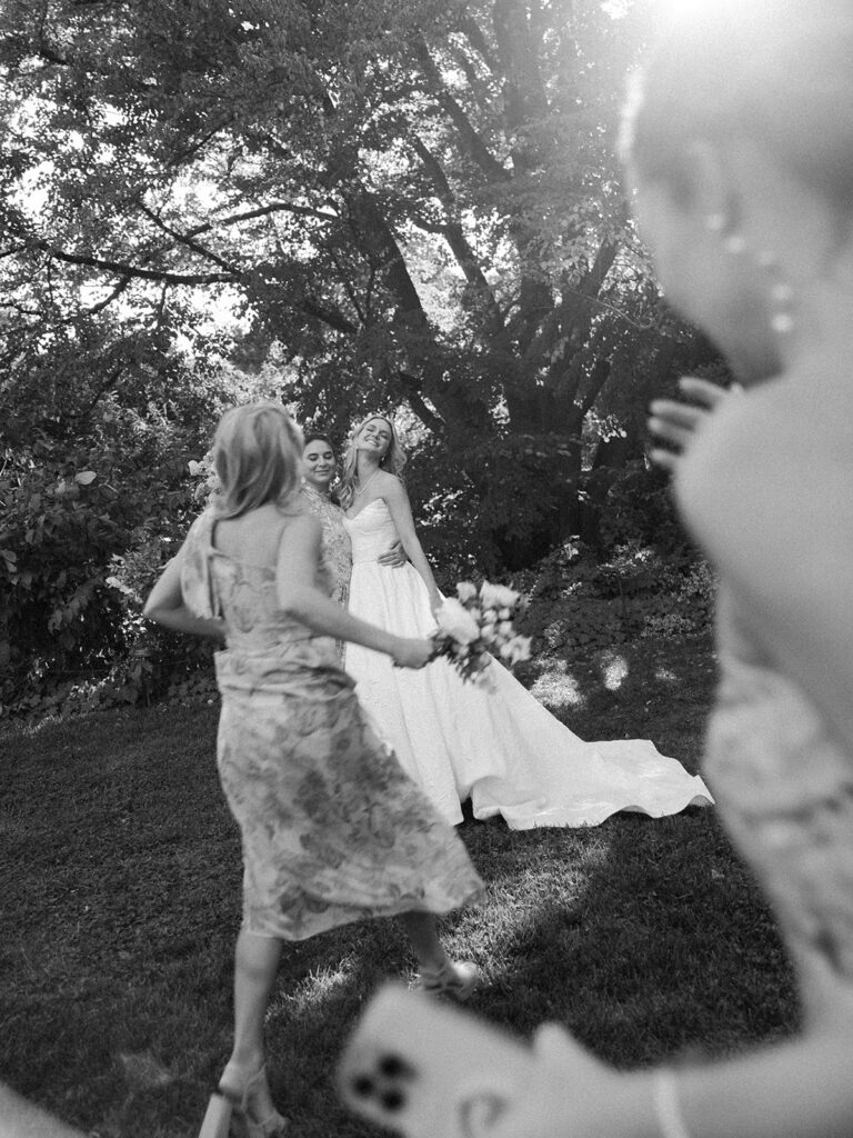 Bride with her friends running towards her at her Brooklyn Botanic Wedding