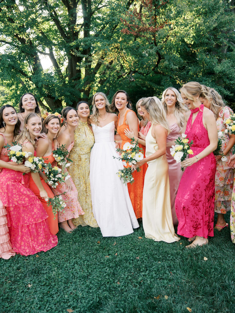Casual group pic of the bridesmaids huddled around the bride at her Brooklyn Botanic Wedding.