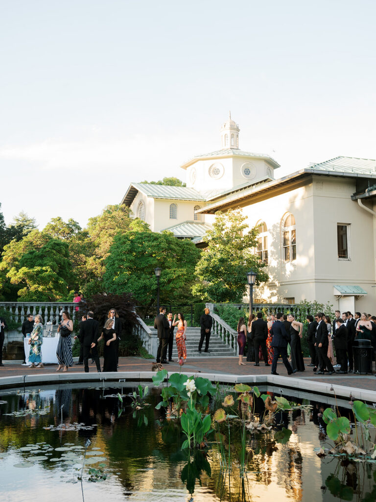 Guests at cocktail hour mingling in the garden.