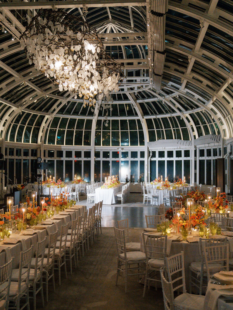 Full room view of the reception space. White tables and chairs.
