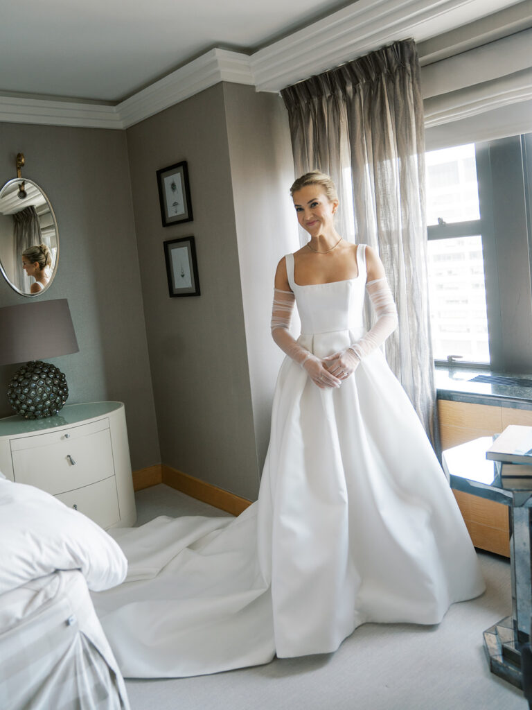 Bride getting ready in the bridal suite looking lovingly at her mom off camera.