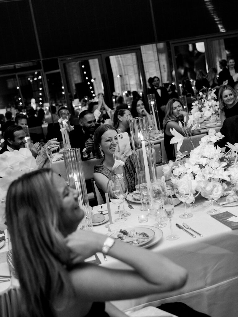 A candid image of the guests enjoying dinner seated at their tables.