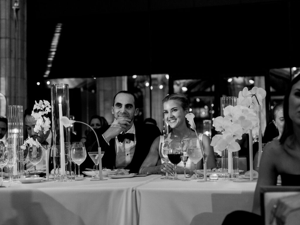 The bride and groom enjoying speeches at their head table.