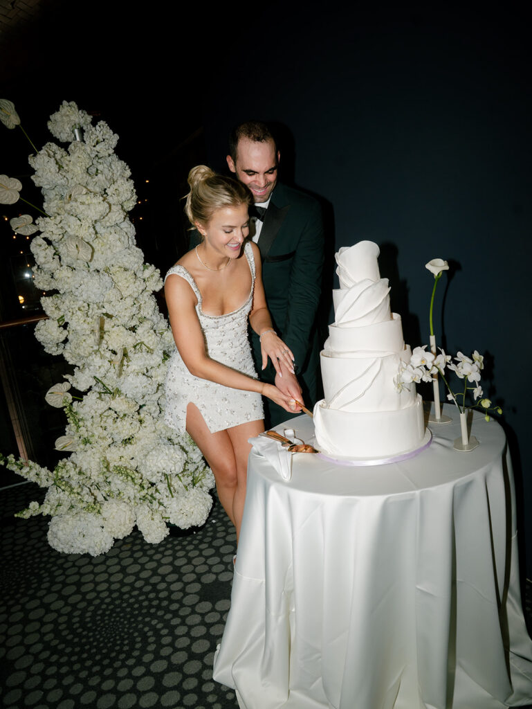 The bride and groom cutting the cake.