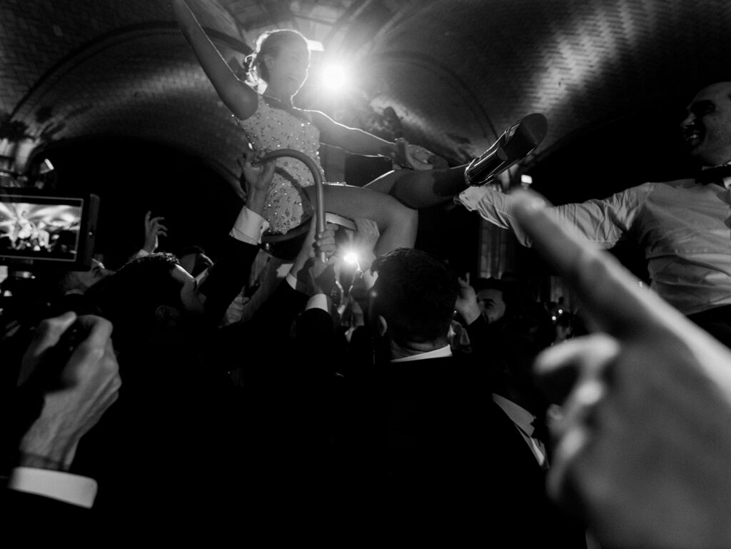 The bride lifted on a chair during the Hora.