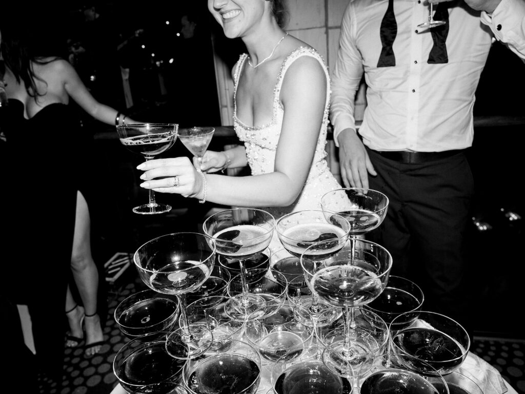 The bride passing out martinis to the guests.