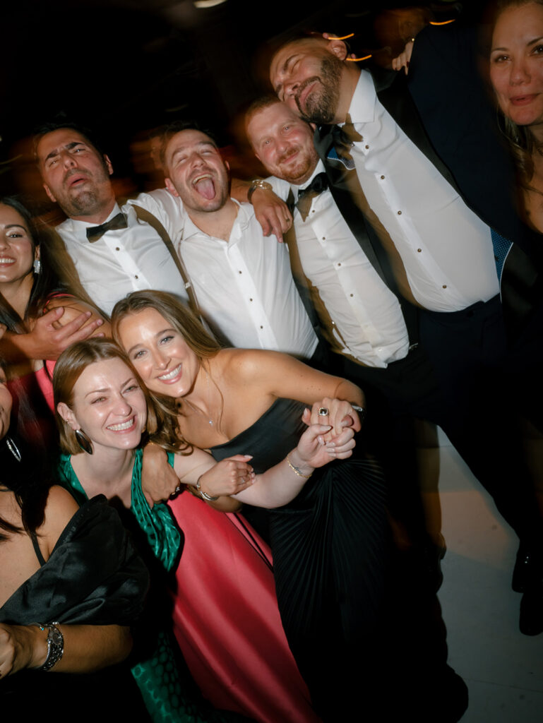 A group photo of guests on the dance floor.