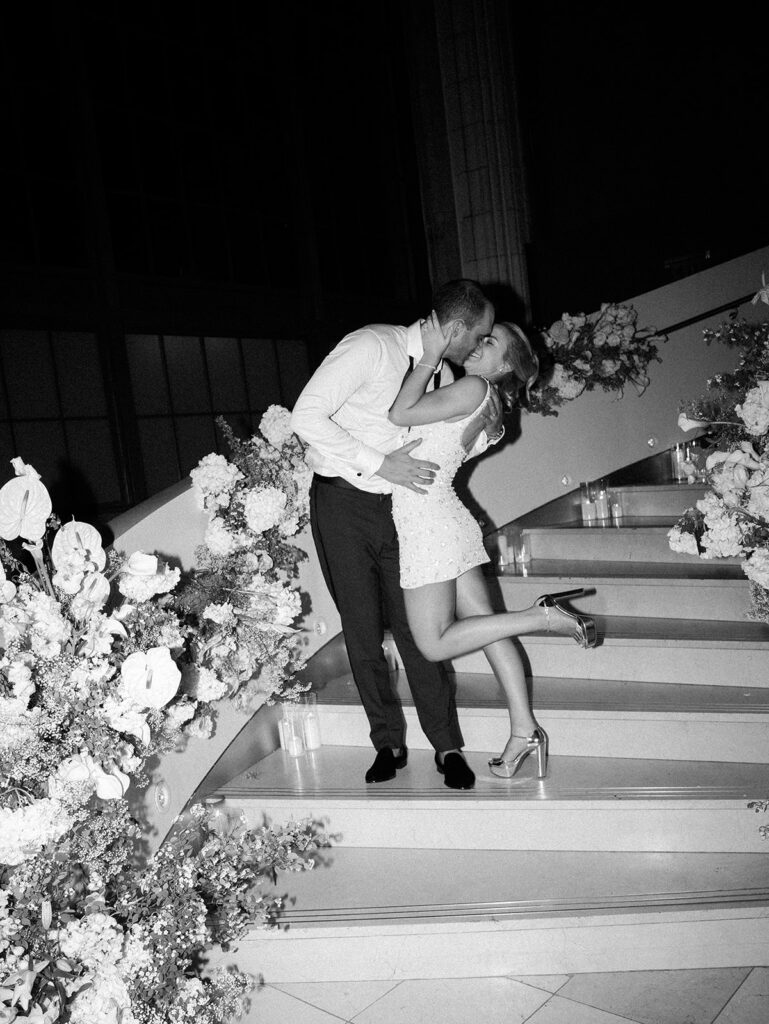 The bride and groom kissing on the stairs at their Guastavino's wedding.