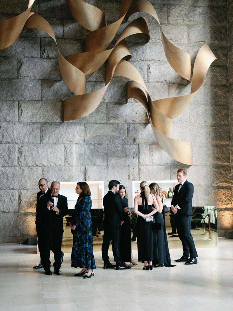 Guests gathered around the bar at Guastavino's wedding.