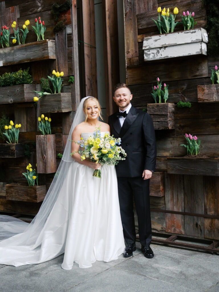 The bride and groom pose for a formal portrait at the hotel before leaving for their wedding.
