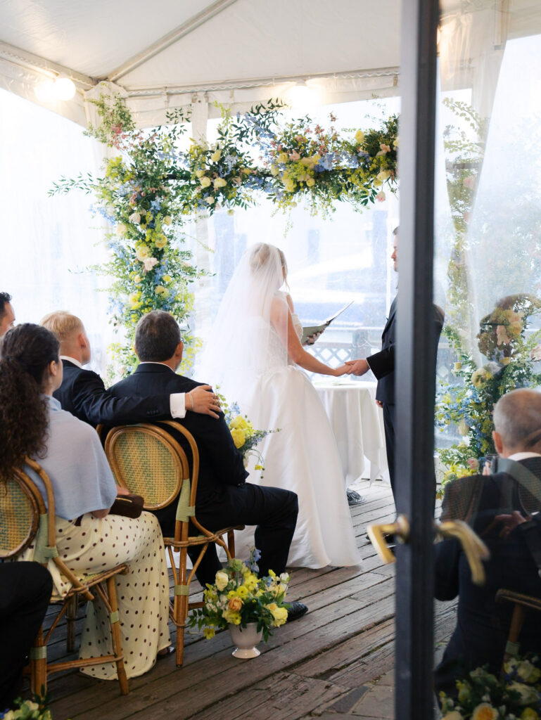 Bride and groom at the altar of their rainy river cafe wedding ceremony in Brooklyn.