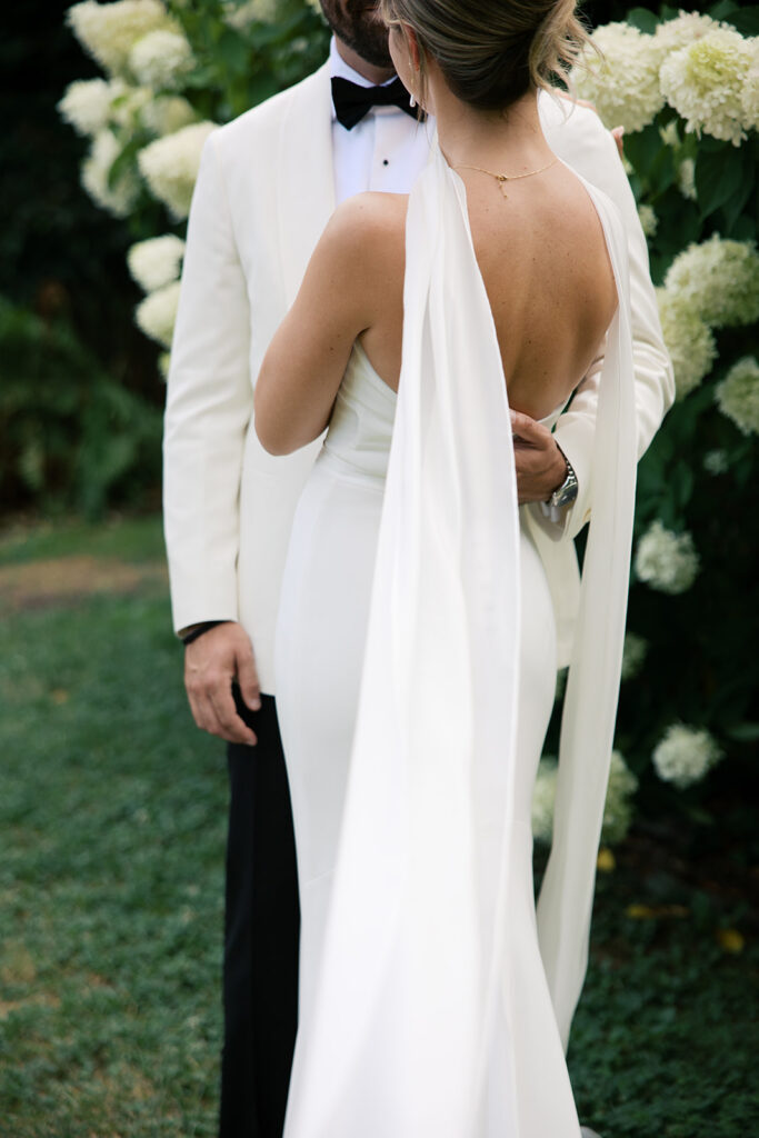 A close up details of the bride's dress from the back.