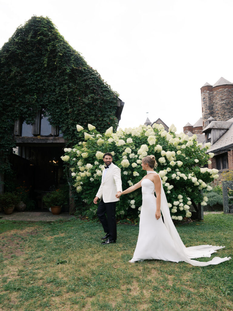 The groom walking the bride to the barns.