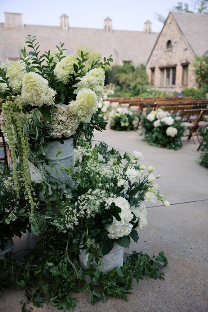 Close up of the floral arrangements at the end of the aisle.