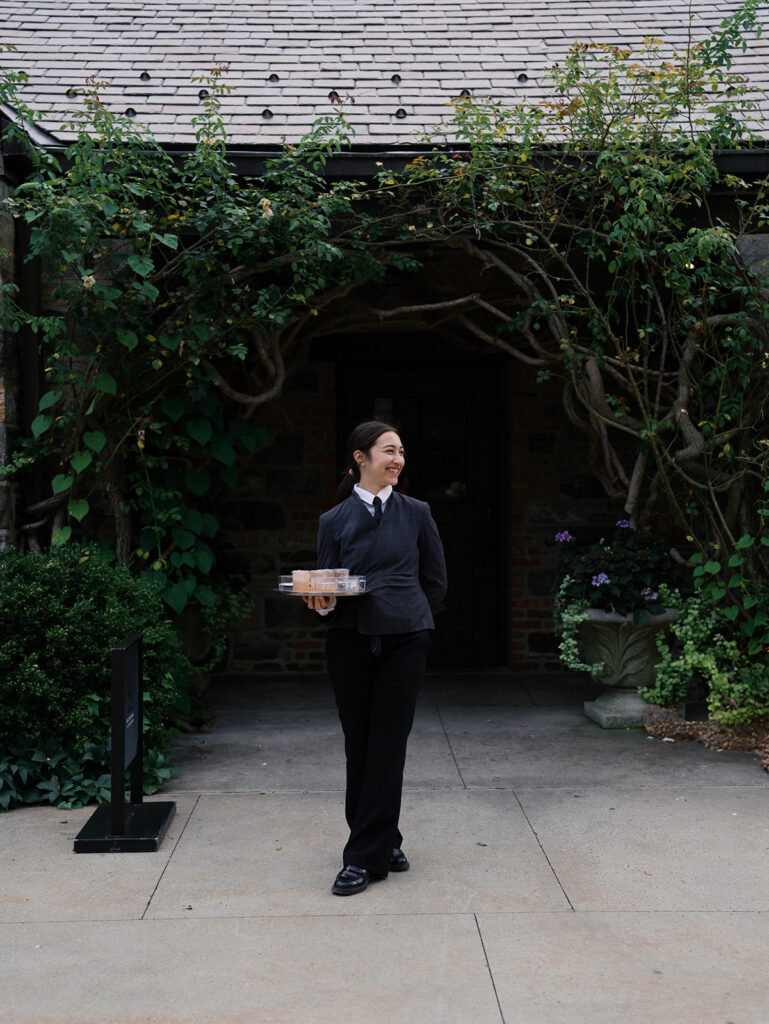 A server at Blue Hill at Stone Barns Wedding waiting for guests to arrive.