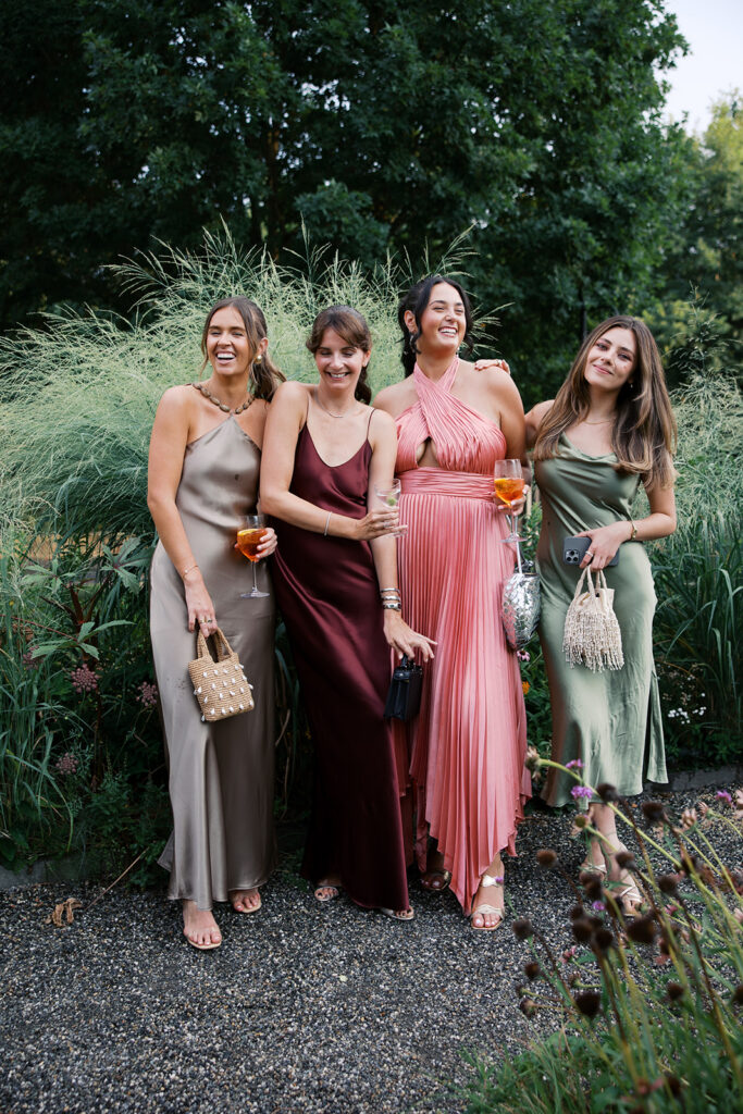 A group of friends in the garden posing for a portrait during cocktail hour.