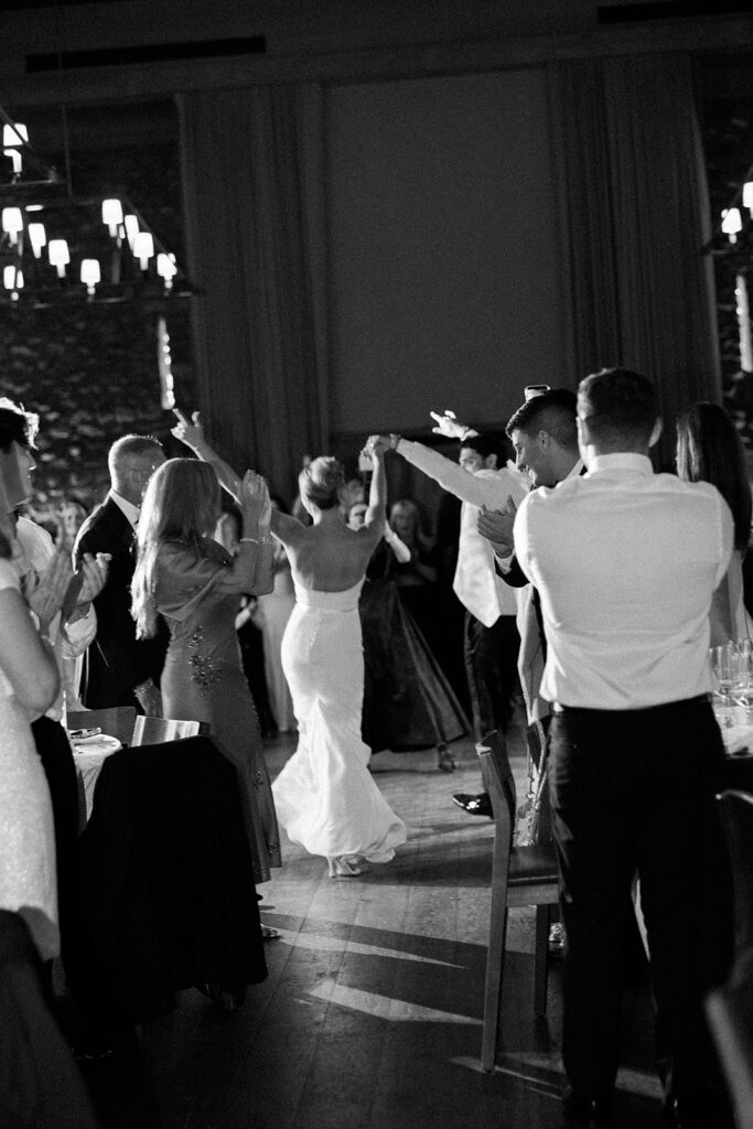 A view from behind as the bride and groom enter the reception.