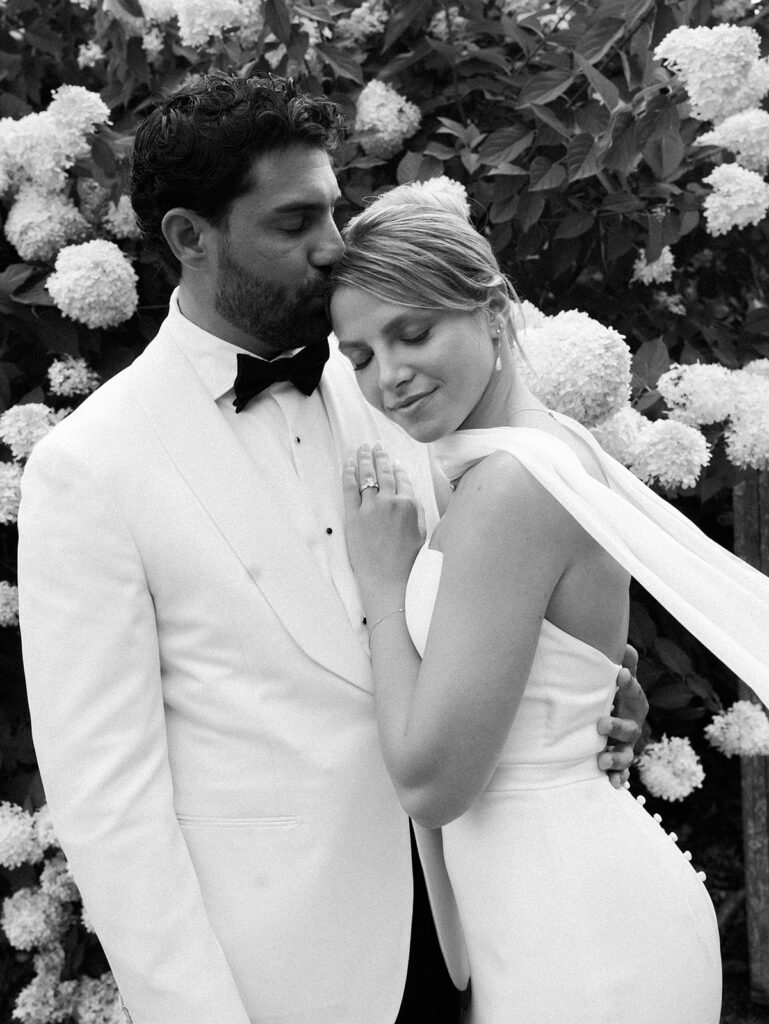 A black and white image of the bride and groom enjoying a snuggle.