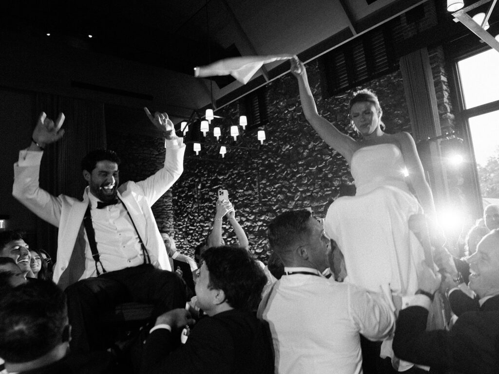 The hora during the reception with the bride and groom being raised on chairs at their Blue Hill at Stone Barns Wedding.